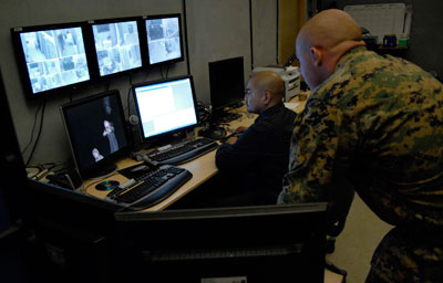 Navy soldiers in front of computer screens.